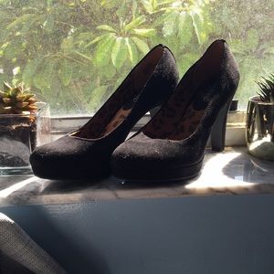 Soft black high heels with signature animal print.